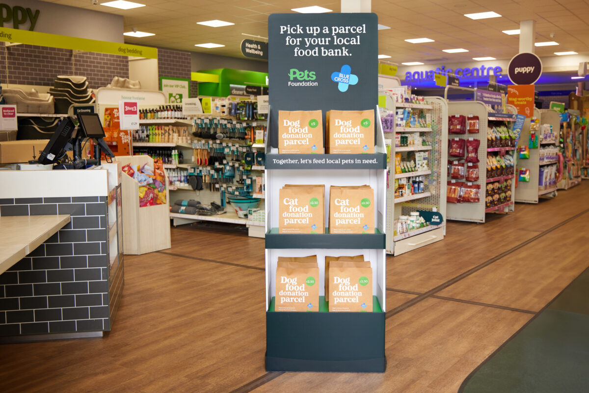 A stand of pet food donation parcels in a Pets at Home store. Pick up a parcel for your local food bank.