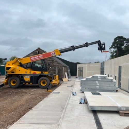 Yellow construction truck at a building refurbishment.